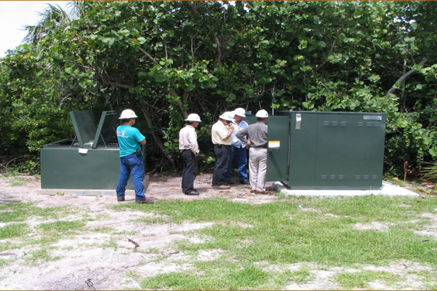 FPL employees gathered around a switch cabinet