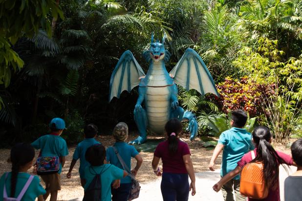 Children stand in front of blue dragon