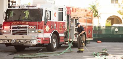 Fire Fighter with Hose and Truck