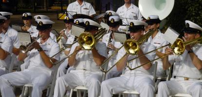 Members of the U.S. Navy Band performing while seated