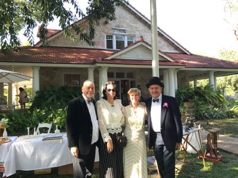Elderly couples in formal attire in front of the Merrick House