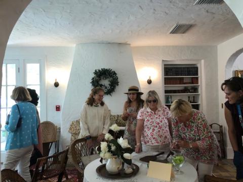 Ladies gathered around a table in the Merrick House